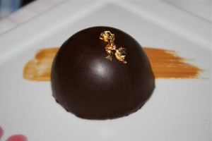 Chocolate bombe dessert with real gold leaf